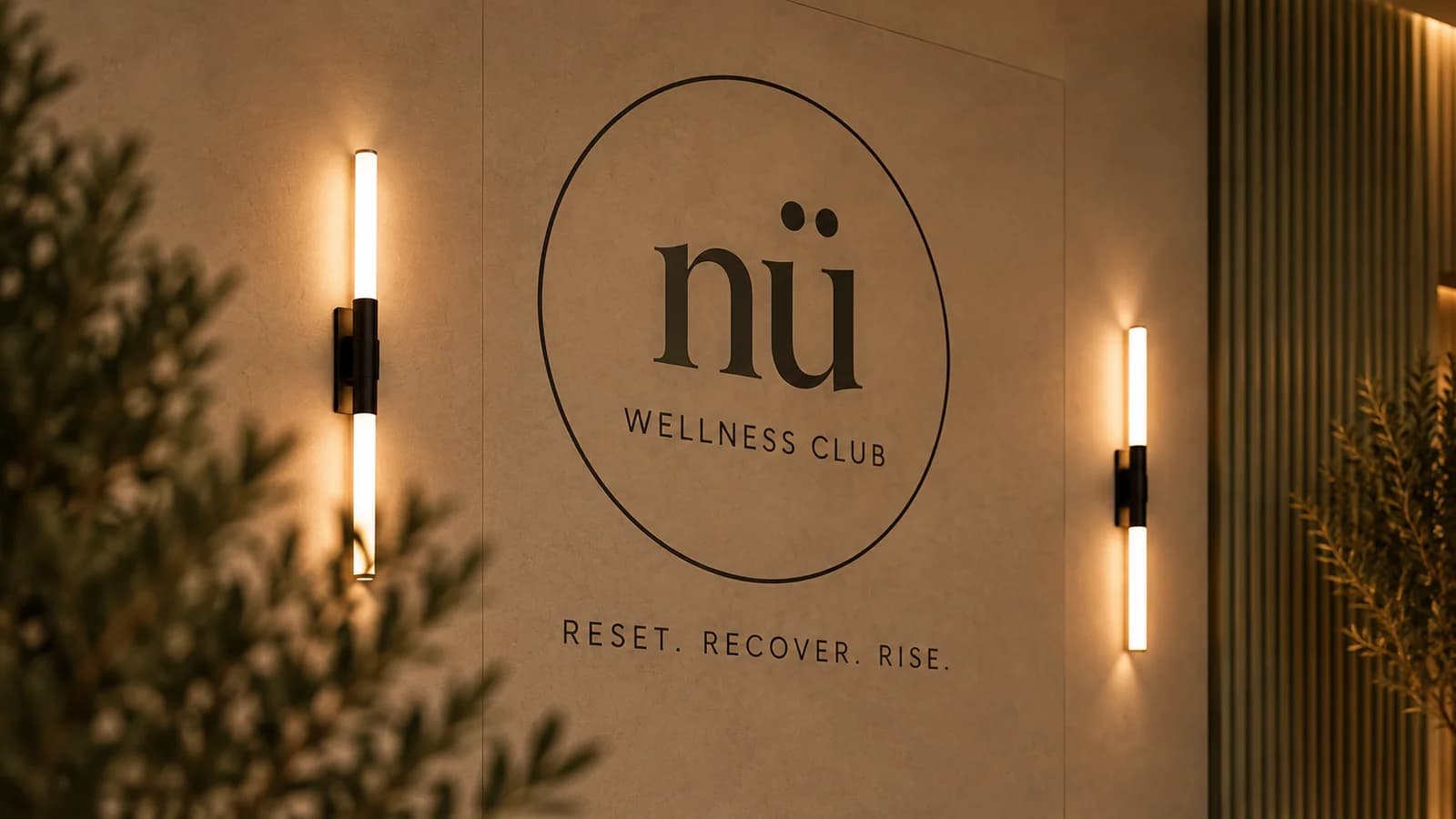 The Nü Wellness Club logo wall with Reset. Recover. Rise. beneath